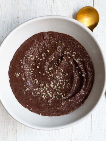 Teff porridge chocolate flavored in a white bowl.
