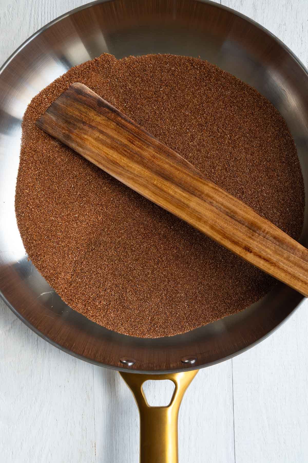 Teff toasted in a skillet.