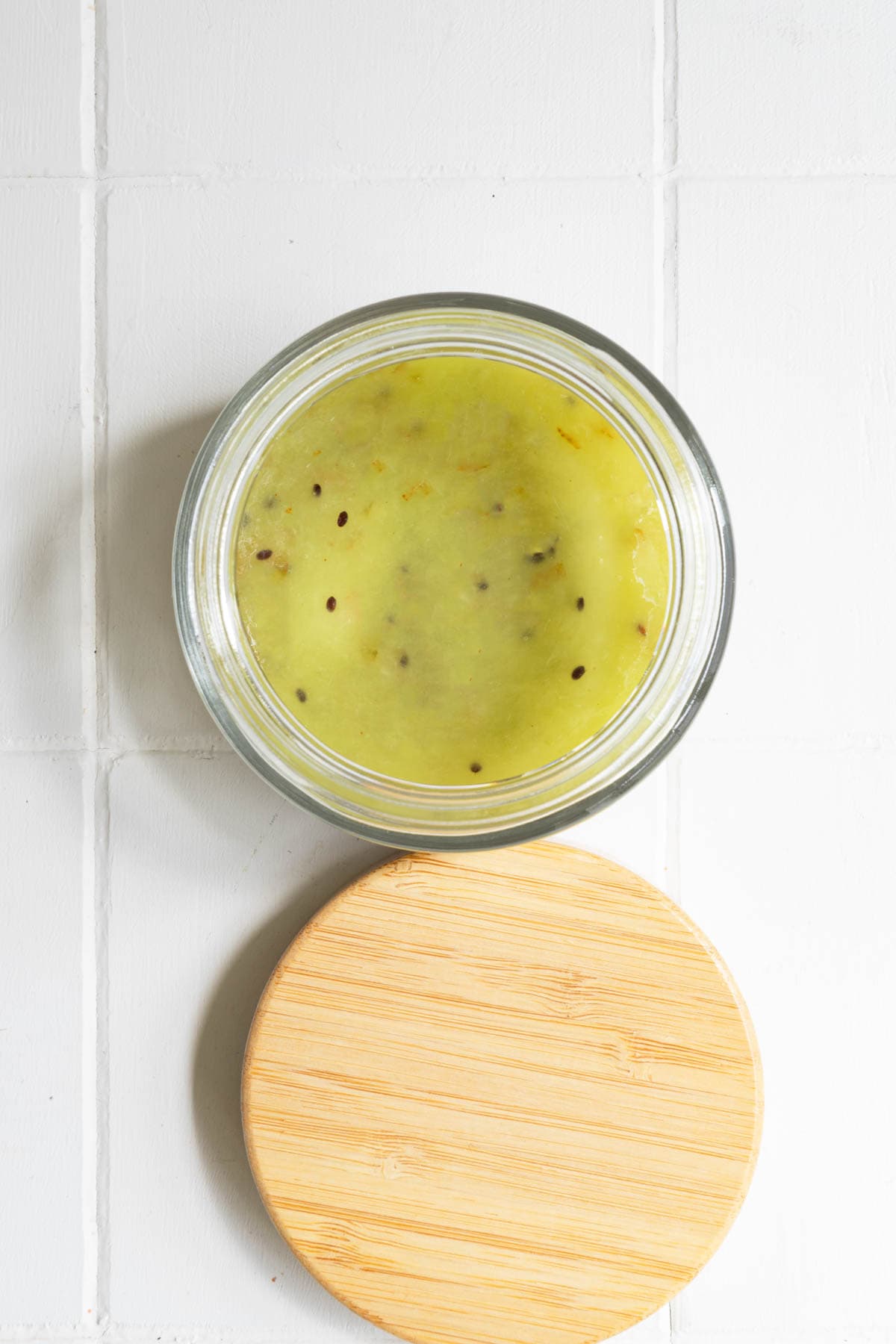 Mashed kiwi in a glass container.