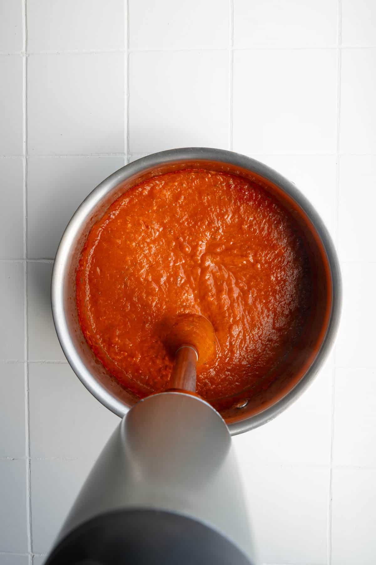 Blended okra tomato sauce in a saucepan wth an immersion blender.