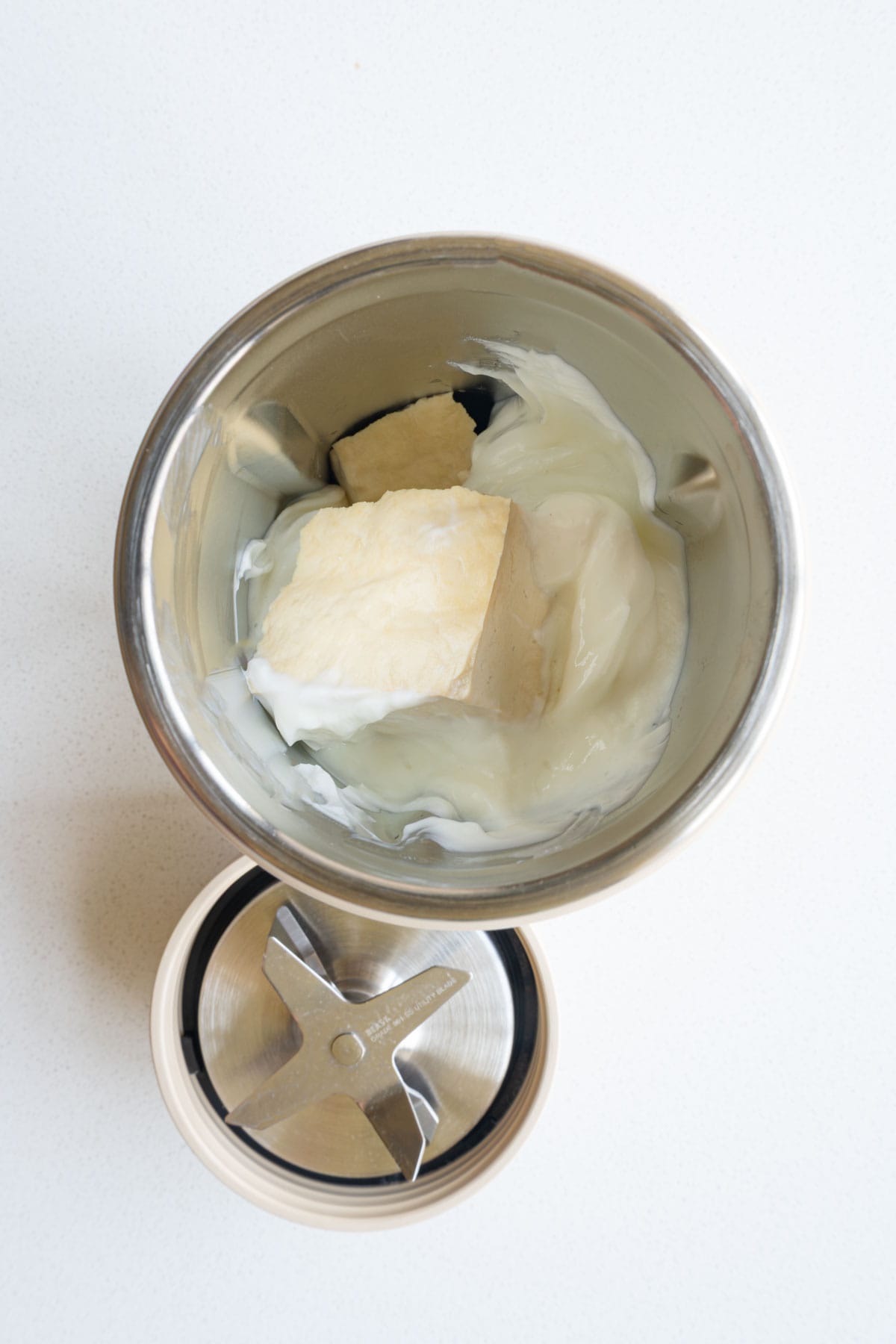Tofu, nondairy milk and yogurt in a blender.