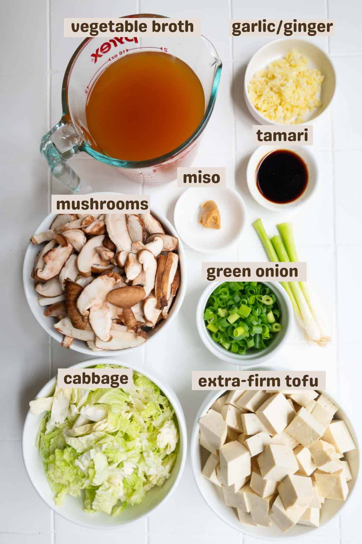 Vegetable broth, garlic, ginger, tamari, miso, mushrooms, cabbage, tofu, and green onion.