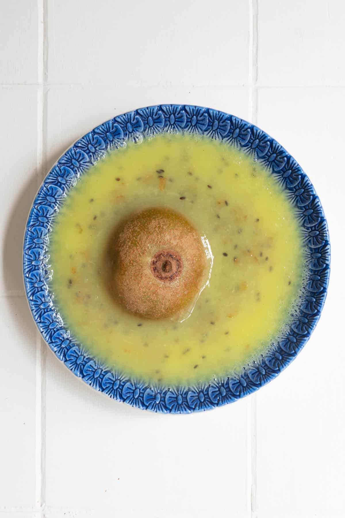 Kiwi being grated on a garlic garter plate.