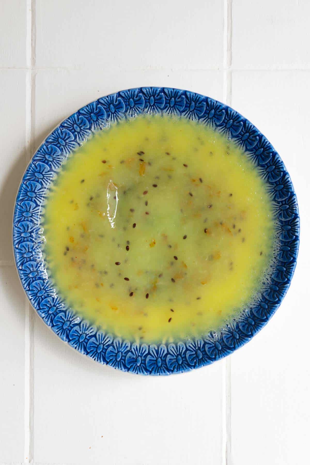 Mashed kiwi on a garlic grater plate.