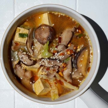 High-fiber high-protein mushroom tofu soup in a white bowl.