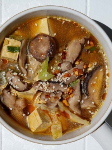High-fiber high-protein mushroom tofu soup in a white bowl.