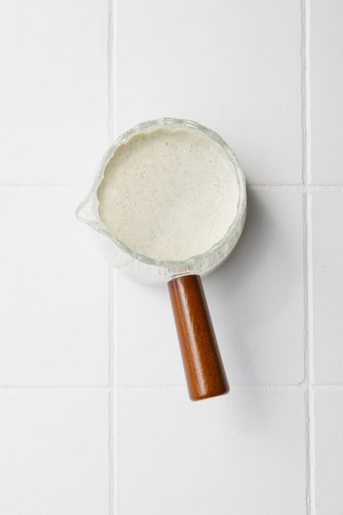 Nondairy cream sauce in a glass jar.