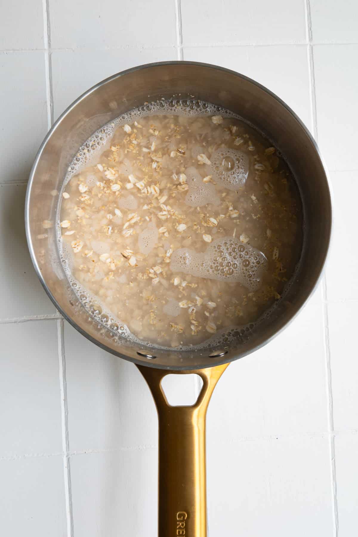 Rolled oats and oat bran in water in a saucepan.