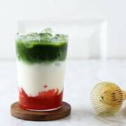 Strawberry matcha latte in a glass with ice.