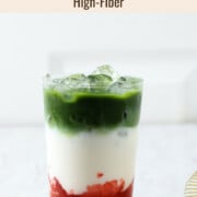 Strawberry matcha latte in a glass with ice.