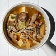 High-fiber high-protein mushroom tofu soup in a white bowl.