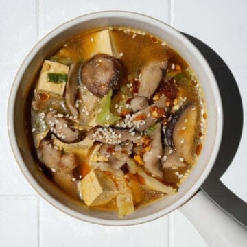 High-fiber high-protein mushroom tofu soup in a white bowl.