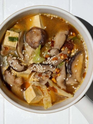 High-fiber high-protein mushroom tofu soup in a white bowl.