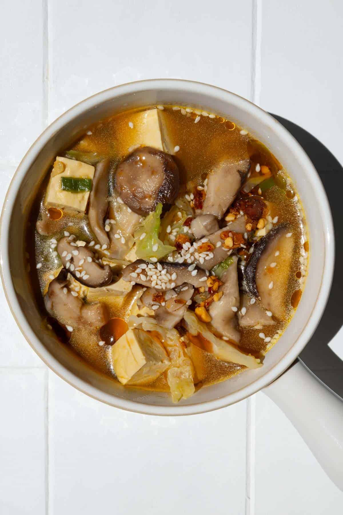 High-fiber high-protein mushroom tofu soup in a white bowl.
