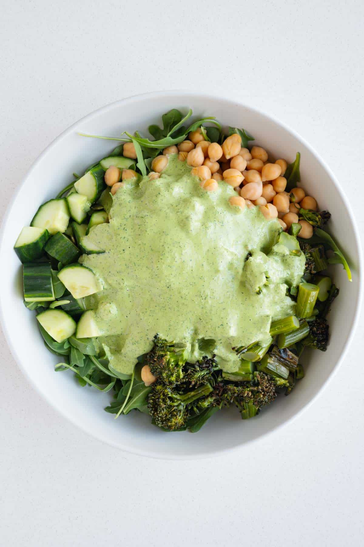 Green goddess dressing with arugula, chickpeas, roasted broccolini, cucumber, and pumpkin seeds.
