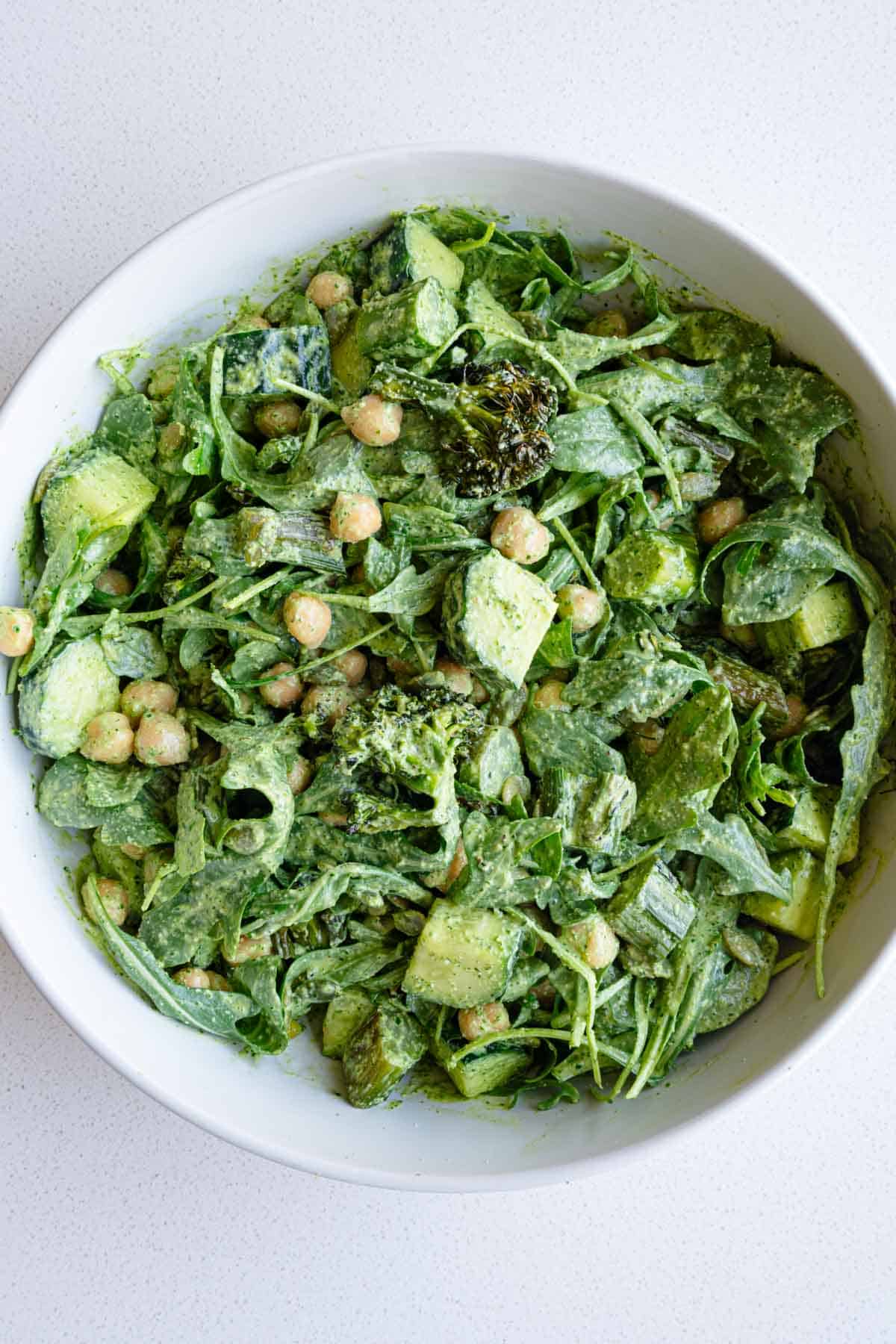 Green goddess arugula salad with chickpeas, roasted broccolini, cucumber, and pumpkin seeds.