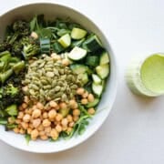 Green goddess arugula salad with chickpeas, roasted broccolini, cucumber, and pumpkin seeds.