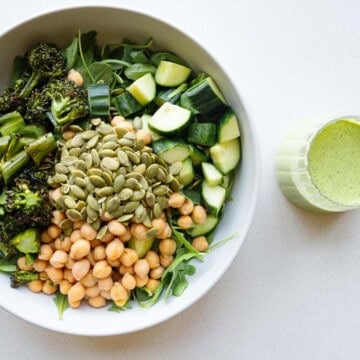 Green goddess arugula salad with chickpeas, roasted broccolini, cucumber, and pumpkin seeds.