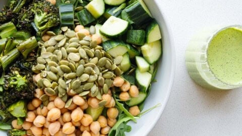 Green goddess arugula salad with chickpeas, roasted broccolini, cucumber, and pumpkin seeds.