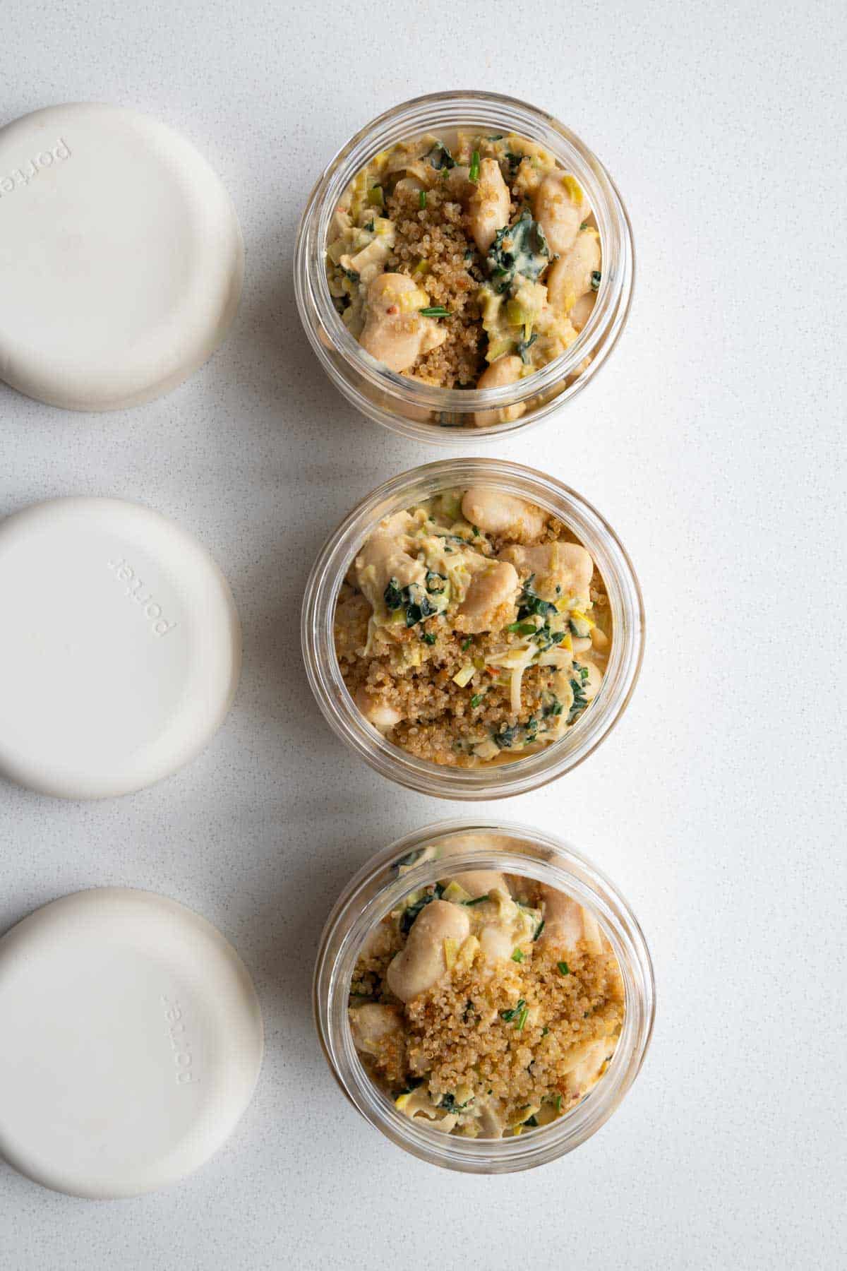 Creamy gigante beans with leek and quinoa in 3 meal prep containers.