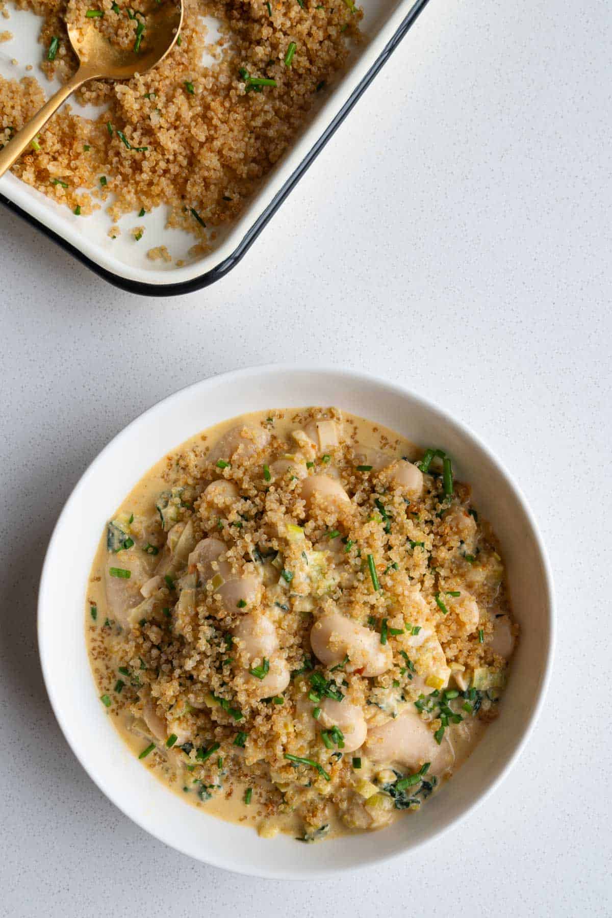 Creamy gigante beans with leek topped with crispy quinoa and chopped chives.