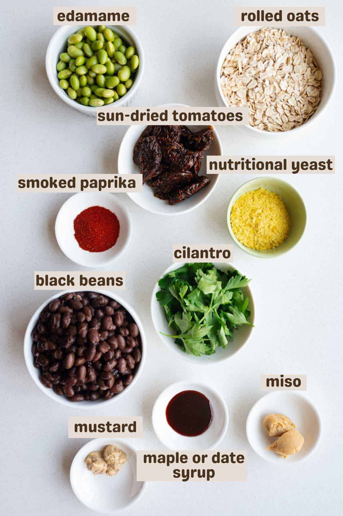 Edamame, black beans, rolled oats, mustard, date syrup, miso, parsley, nutritional yeast, smoked paprika, sun-dried tomatoes, and edamame.