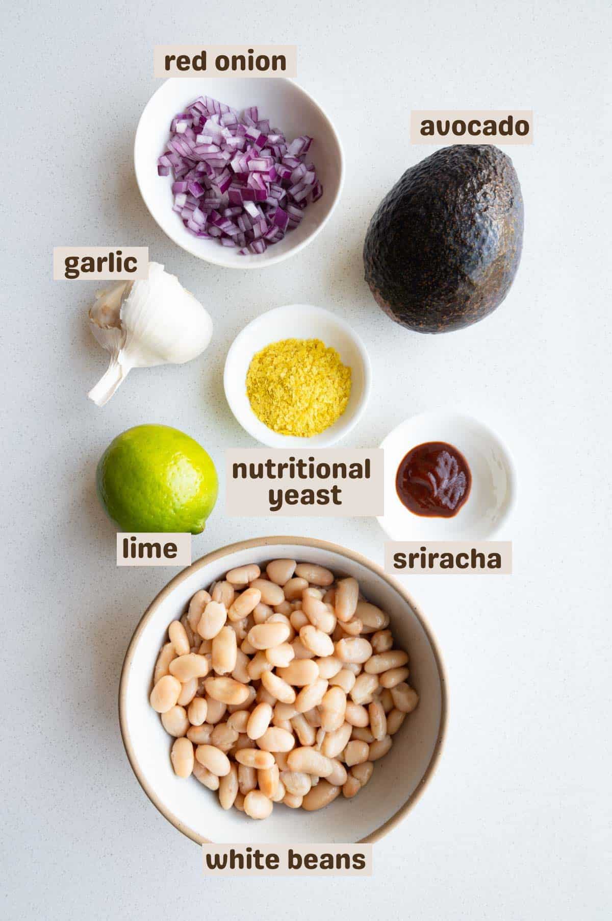Avocado, white beans, nutritional yeast, chopped red onion, sriracha, lime and garlic.