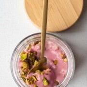 Oat groats parfait in a jar with a spoon.