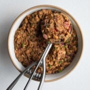 Pinto bean smash in a bow/ with an ice cream scoop.