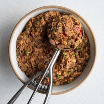 Pinto bean smash in a bow/ with an ice cream scoop.