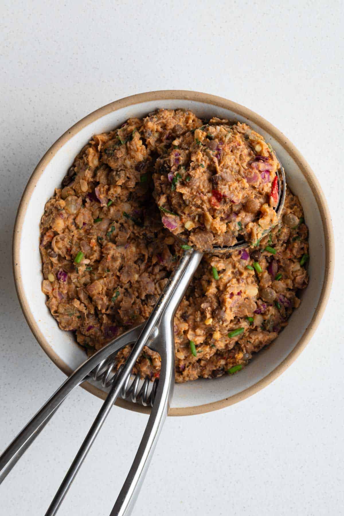 Pinto bean smash in a bow/ with an ice cream scoop.