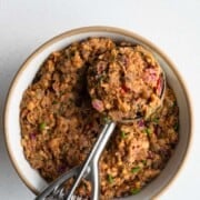Pinto bean smash in a bow/ with an ice cream scoop.