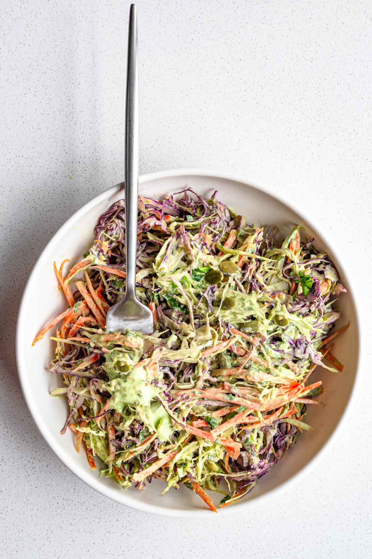 Red cabbage coleslaw without mayonnaise in a white bowl.