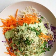 Red cabbage coleslaw without mayonnaise in a white bowl.