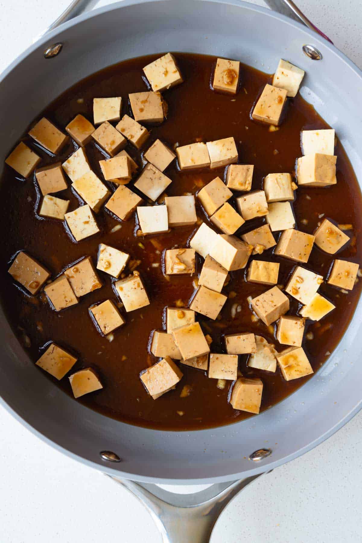 Soy maple marinated tofu in a skillet.