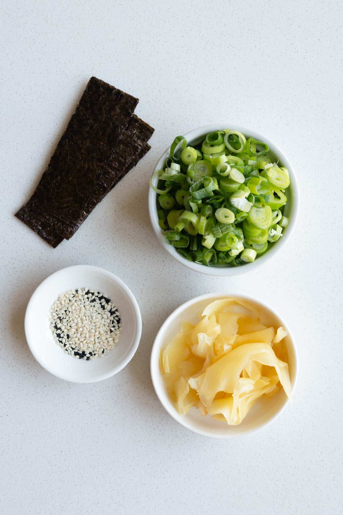 Nori, sesame seeds, pickled ginger, and scallions.