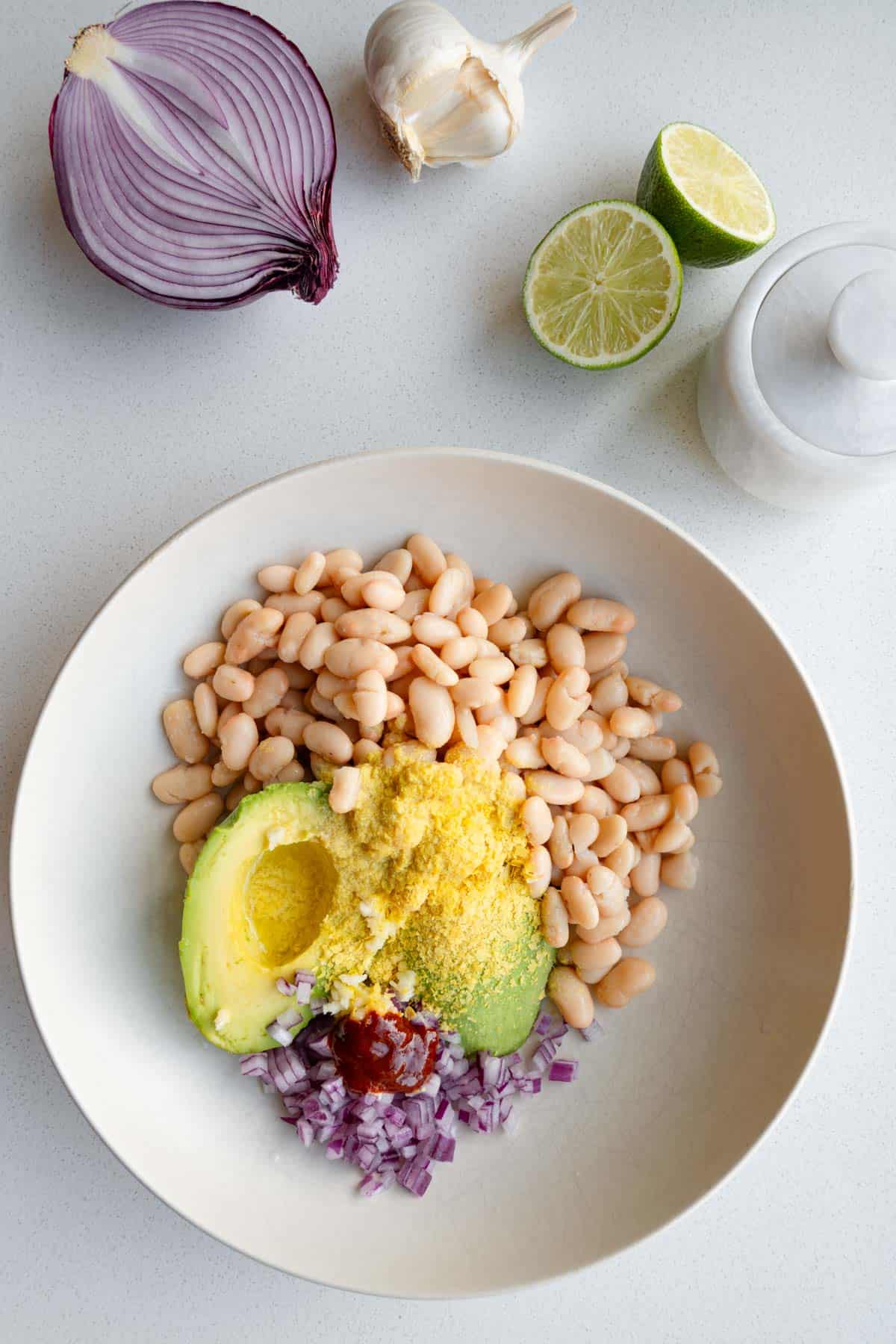 Avocado, white beans, nutritional yeast, chopped red onion, sriracha, lime and garlic.