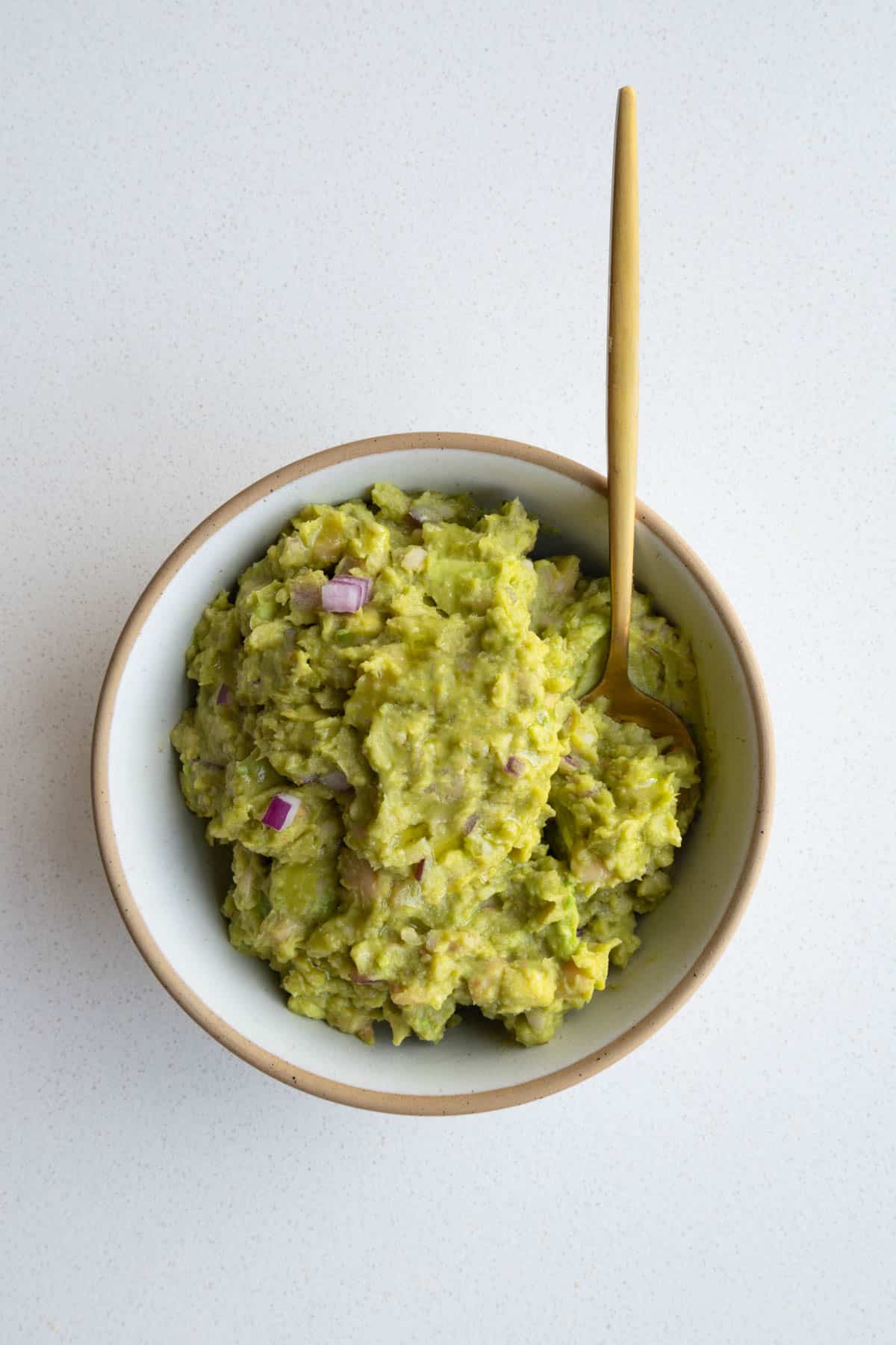 White bean mash in a bowl with an ice cream scoop.