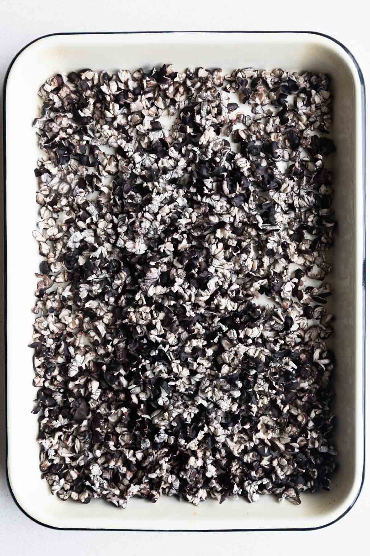 Baked black beans on a baking sheet.