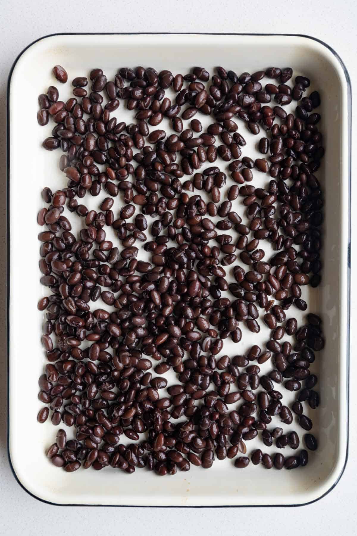 Black beans on a baking sheet.