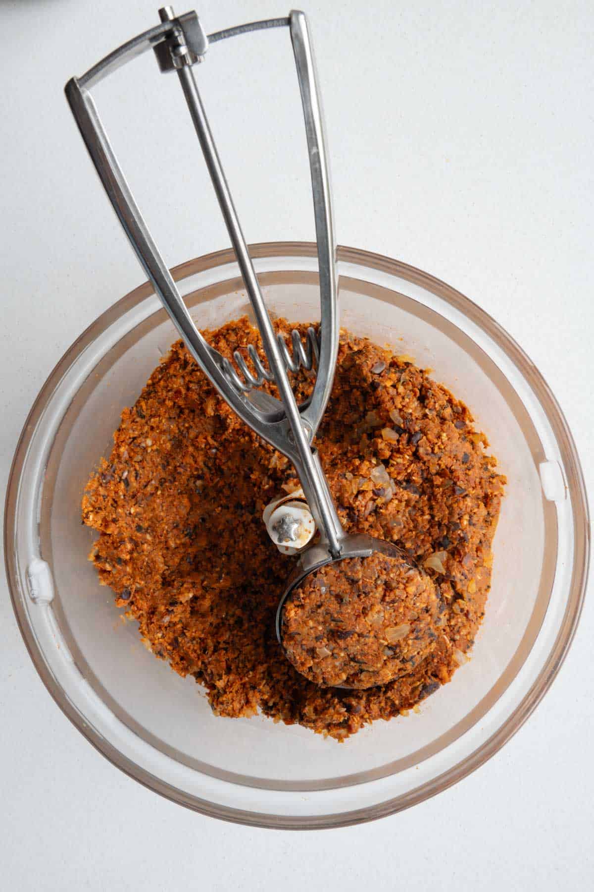 Patty mixture in the food processor with an ice cream scooper.