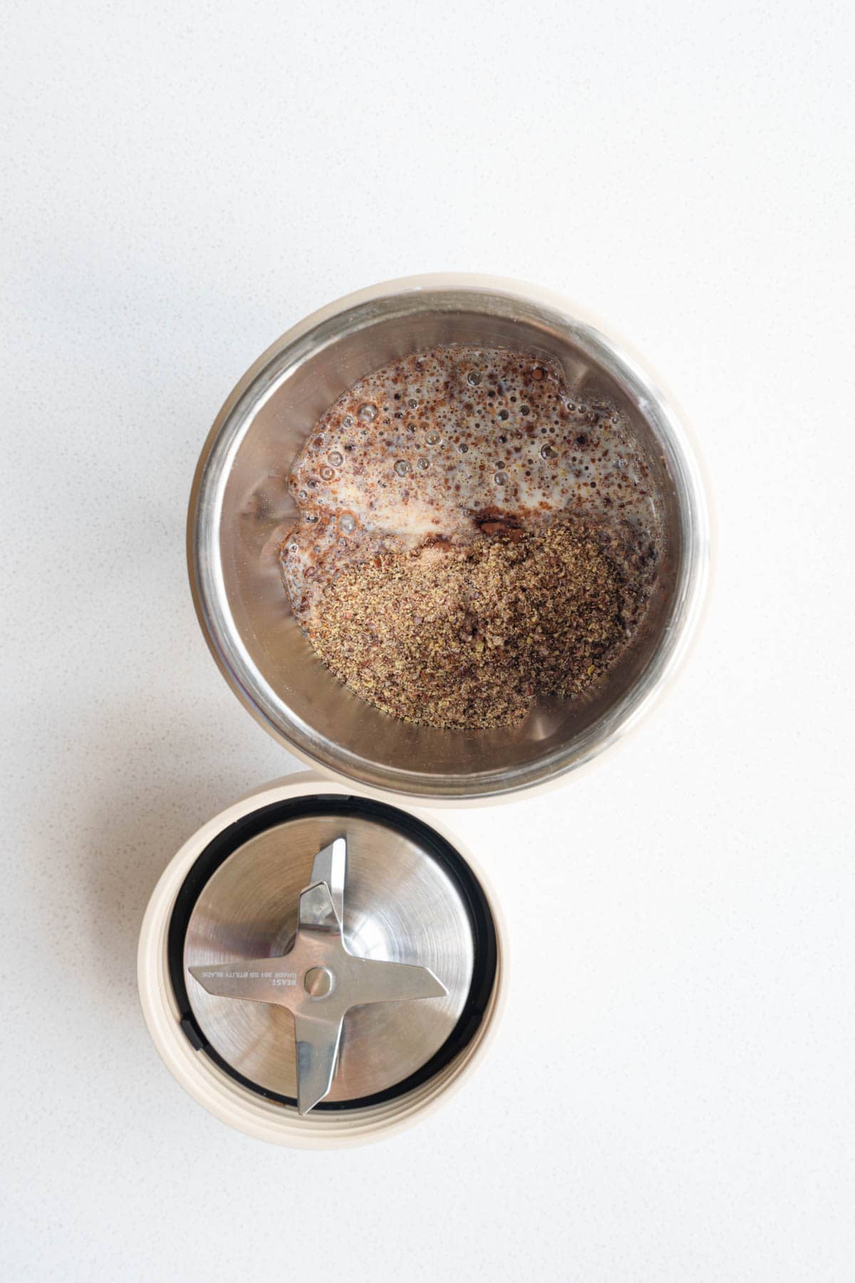 Flaxseed meal, nondairy milk, cocoa powder, psyllium husk, silken tofu, and Medjool dates in a blender.