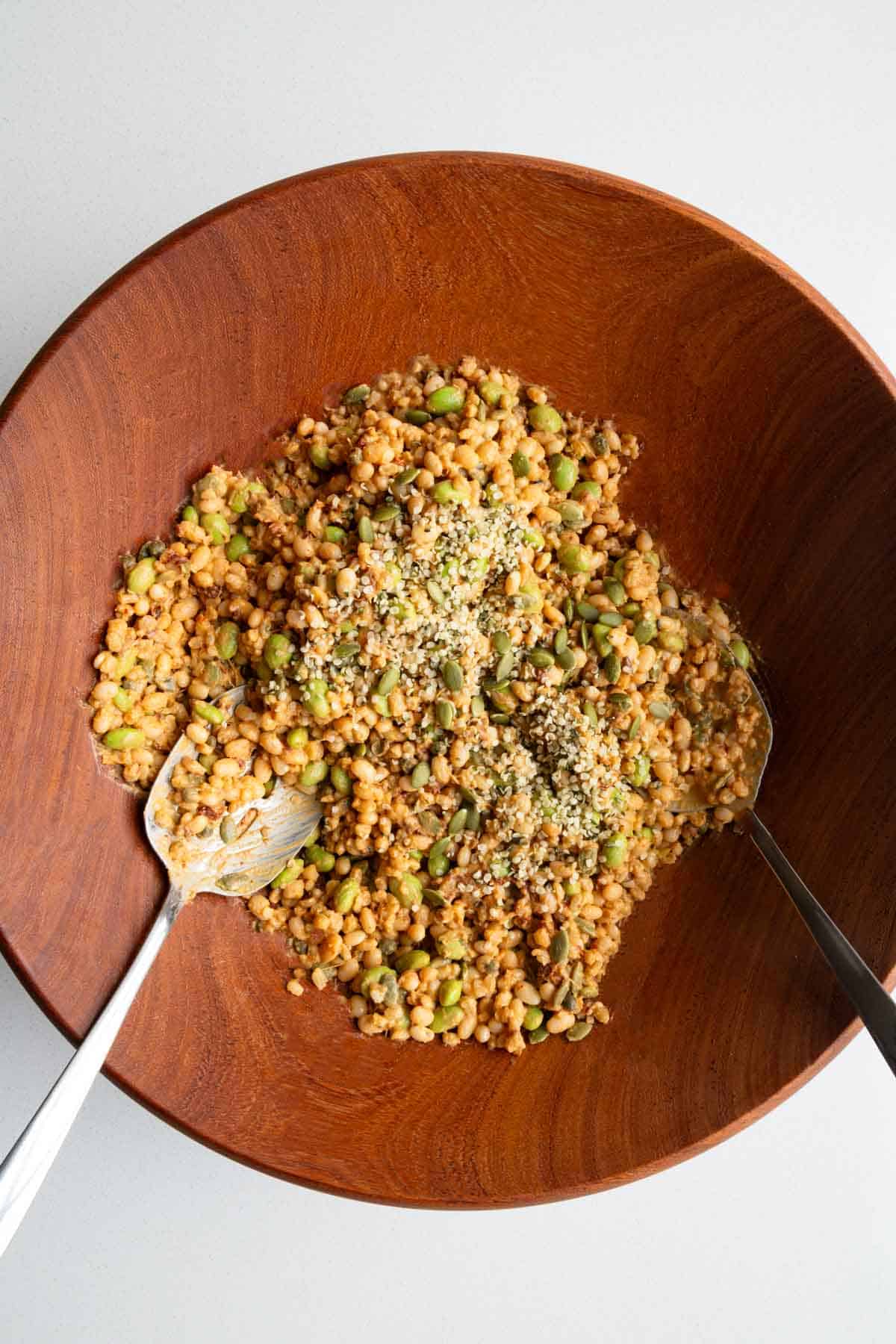 Wooden bowl with creamy bean and barley salad.