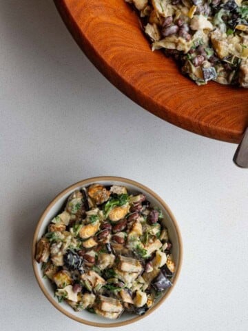 Eggplant salad in a large wooden bowl and in a small serving bowl.