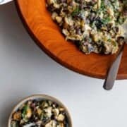 Eggplant salad in a large wooden bowl and in a small serving bowl.