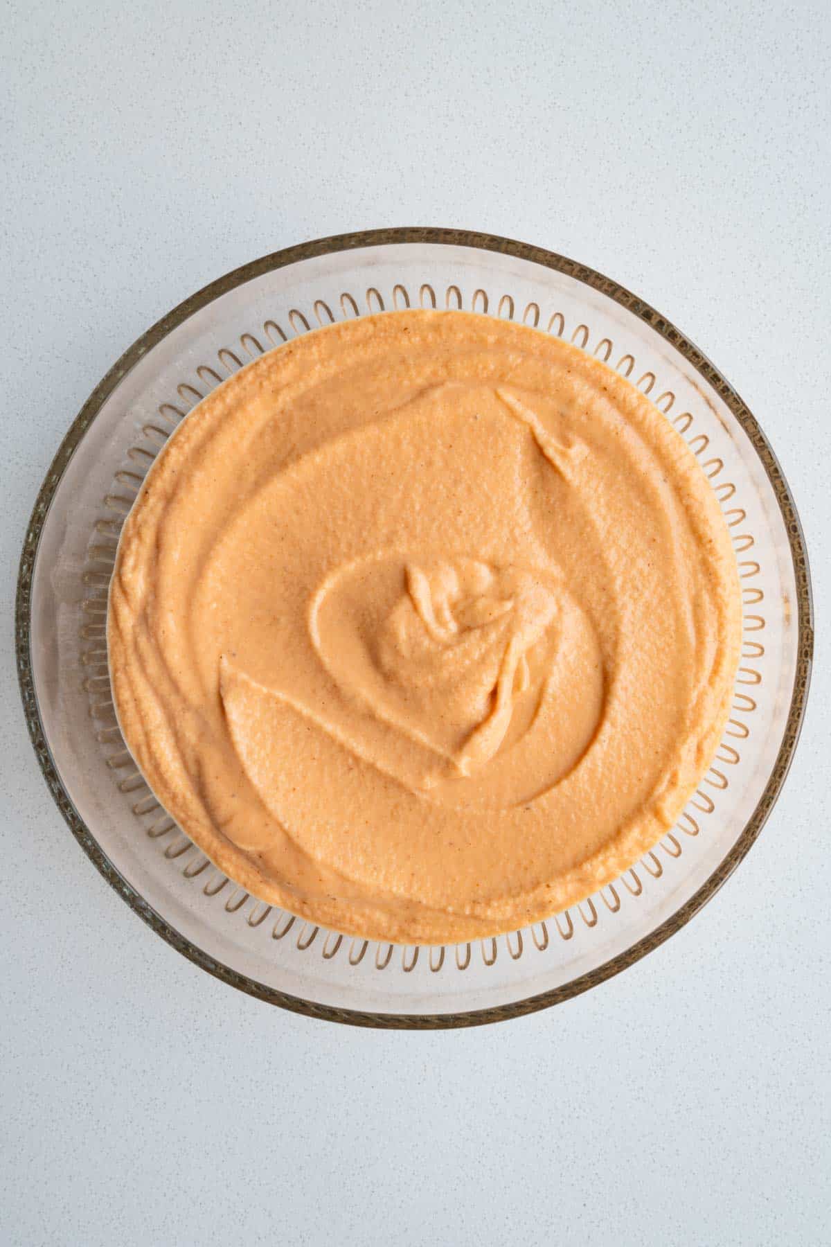 Blended red lentil high-protein cake batter in a glass bowl.