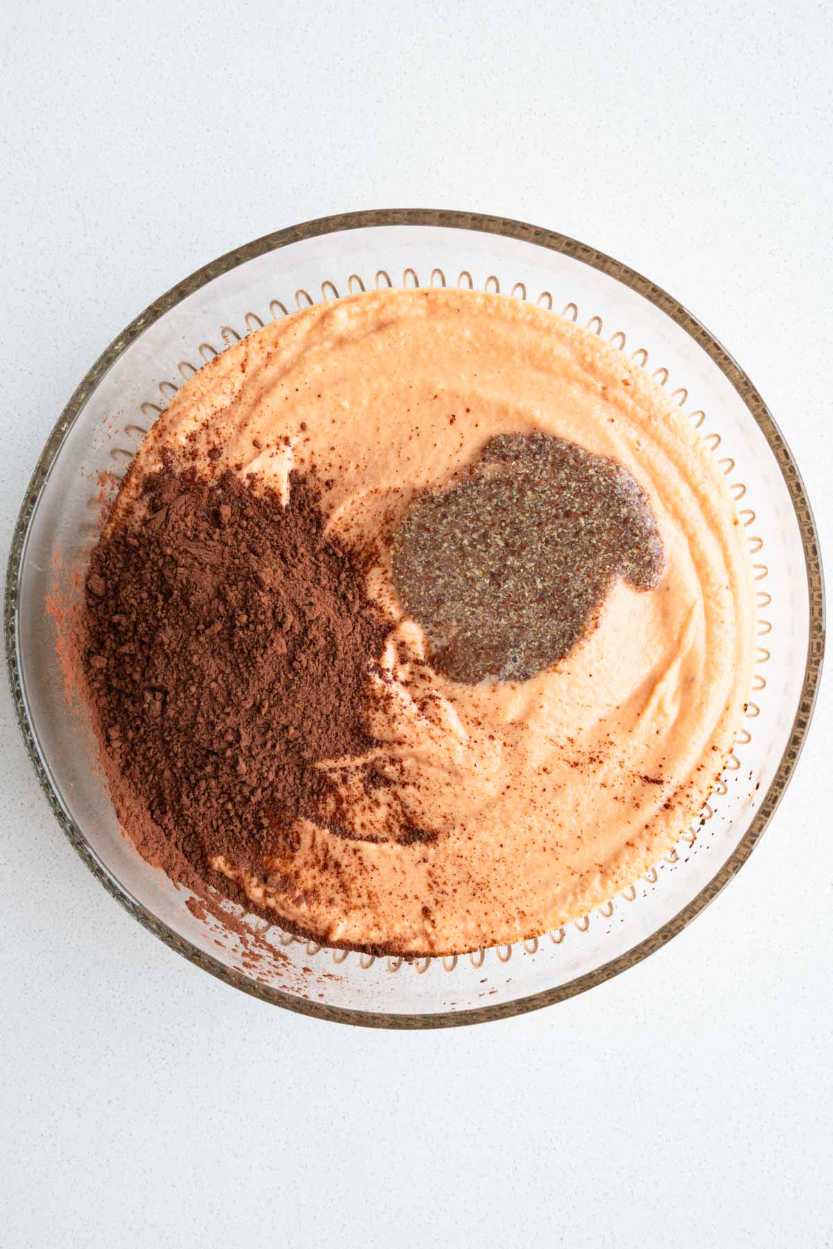 Flax egg, cocoa powder, and cake batter in a bowl.