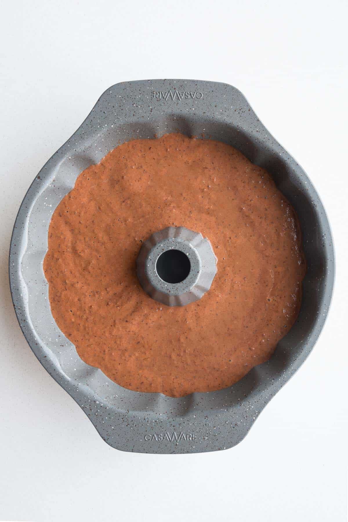 Chocolate cake batter in a bundt cake mold.