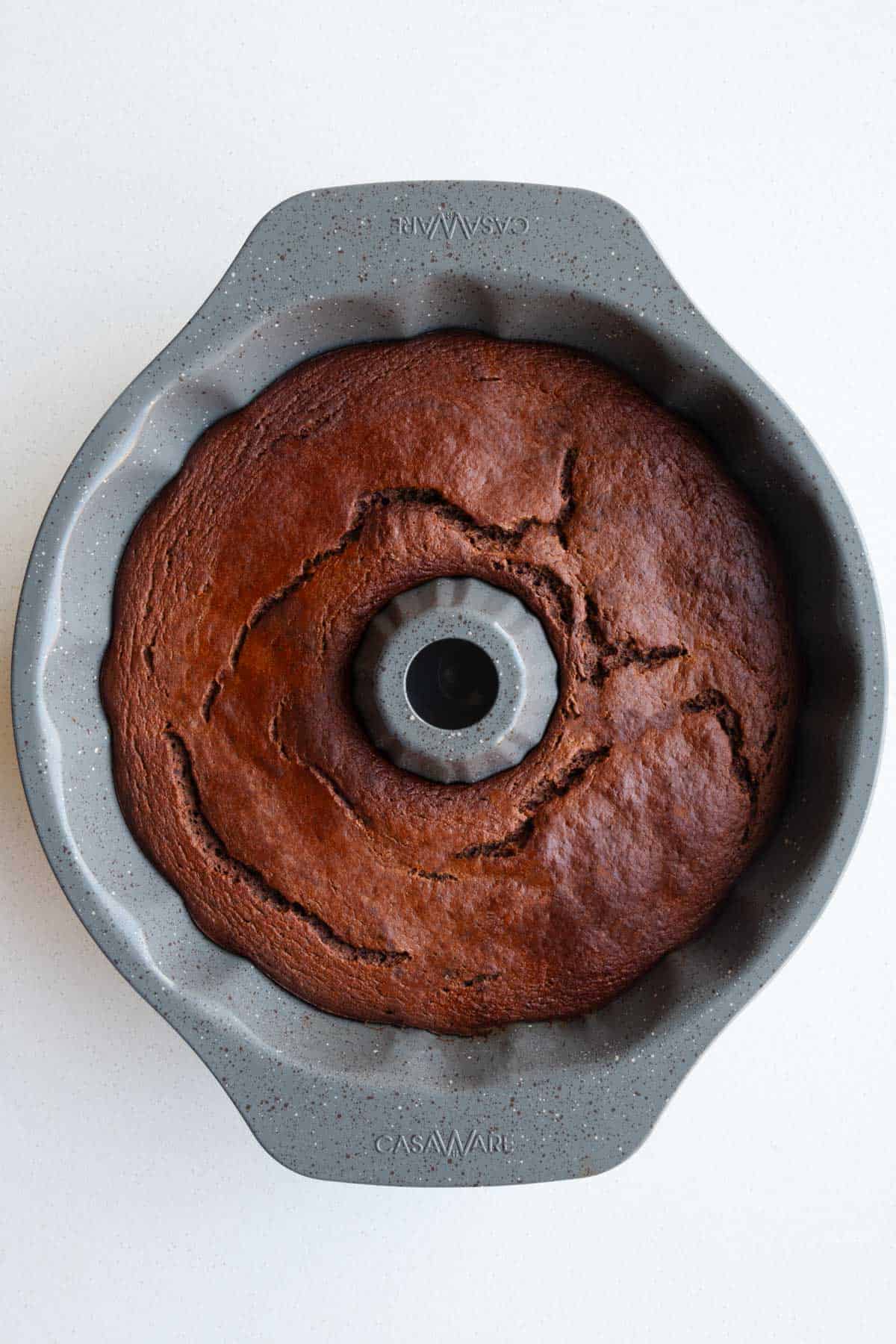 Baked chocolate cake batter in a cake mold.