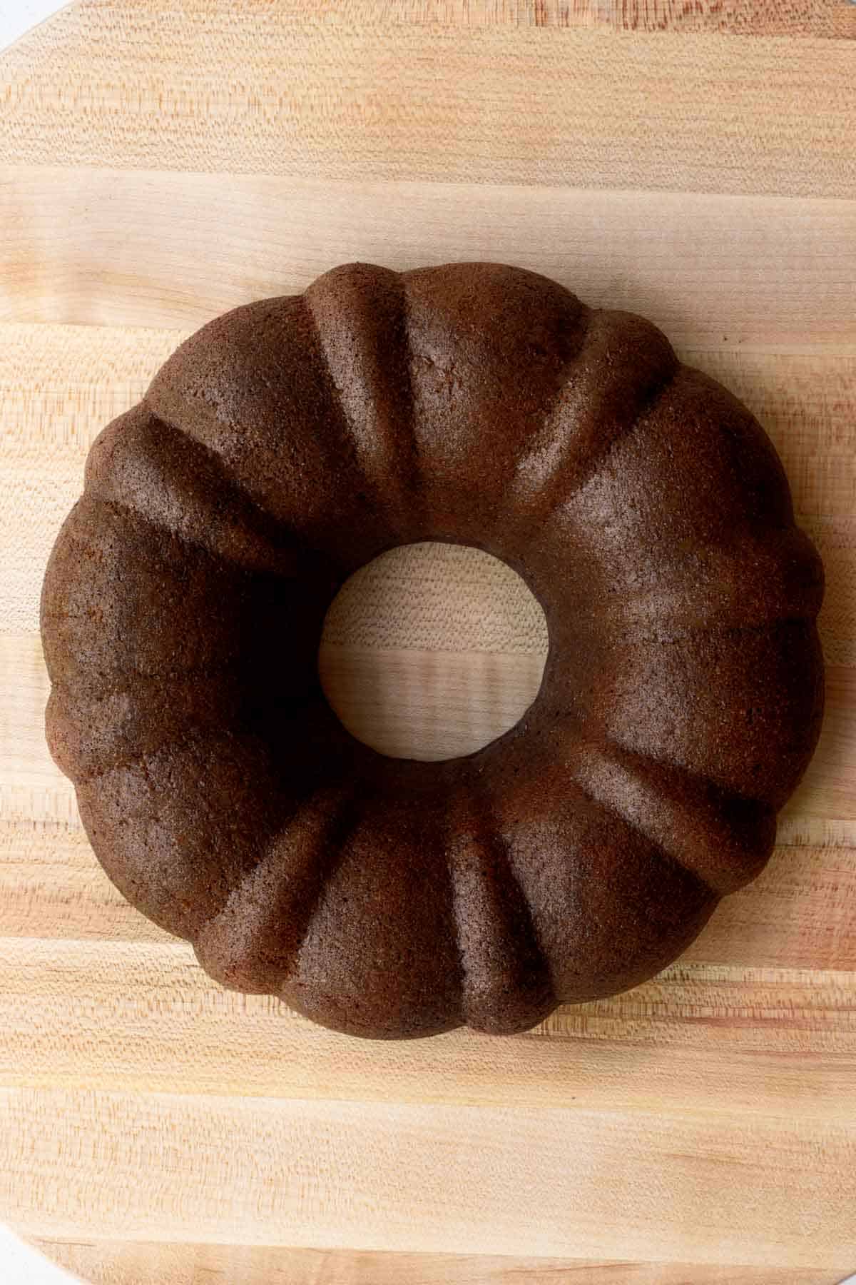 High-protein chocolate cake sliced on a cutting board. Vegan, flourless, and healthy.